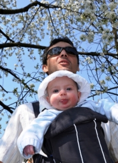 picture of baby in a sling with father on babies and signing website