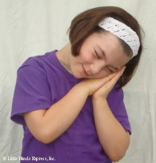 little girl signing the word sleep in sign language