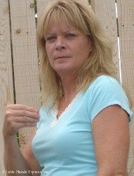 Image shows a blond woman making the asl sign for the color white from a side view Image shows a blond woman making the asl sign for the color white from a side view